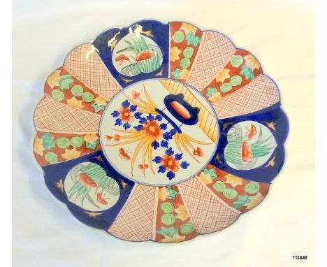 A Japanese Imari plate with wavy rim edge