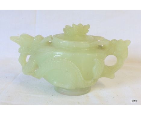 An Oriental tea pot with dragon surround