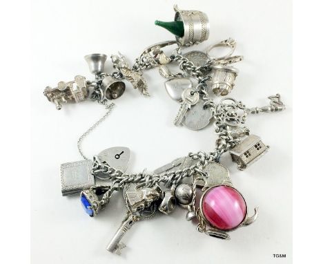 Silver charm bracelet and 24 charms