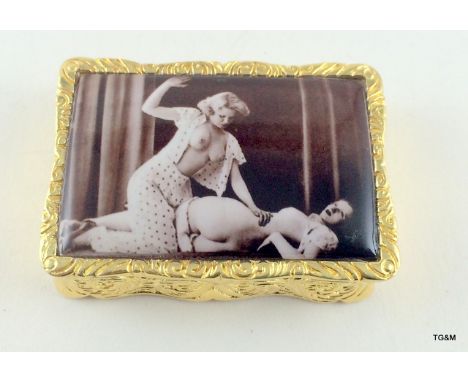 A gold plated on silver decorative pill box with nude enamel image