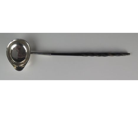 A George III silver toddy ladle, makers mark worn possibly T.S, London, 1779, monogrammed, mounted on a baleen spiral twist h