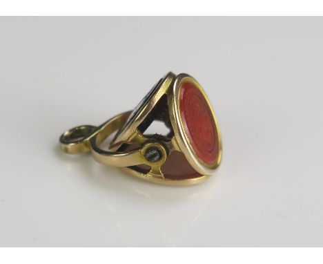 A 19th Century Triple Spinning Fob Seal in a precious yellow metal setting, 12.4x9.8mm matrixes: one agate with initials, one