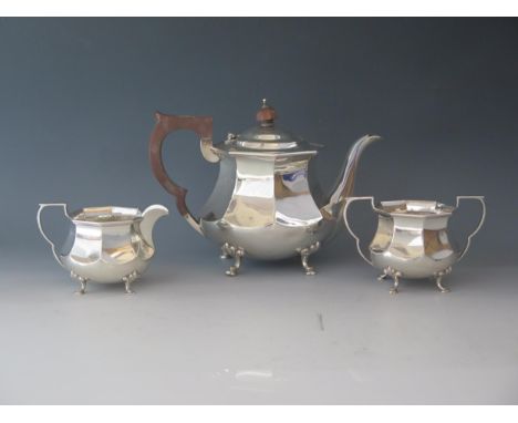 An Edward VII silver three-piece tea service, maker Adie Brothers Ltd, Birmingham, 1902, of squat octagonal form, raised on c