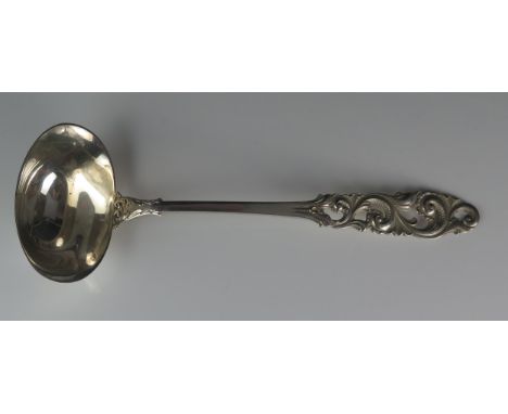 A Norwegian silver ladle, stamped marks, 830S for Brodrene Mylius, with oval-shaped bowl on a pierced and scroll decorated ha