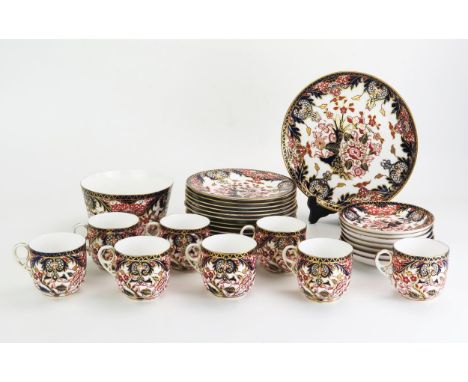 A Royal Crown Derby porcelain part tea service, with floral decoration in the Imari palette, includes seven saucers, eight te