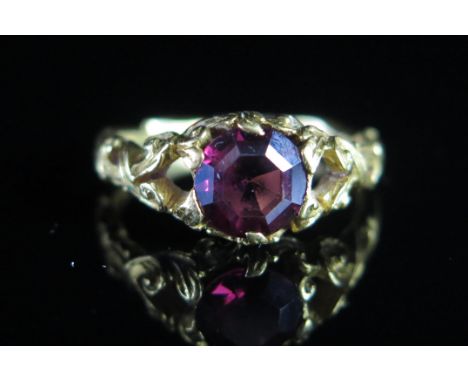 A Georgian 'Ruby' Paste Ring in a precious yellow metal setting with pierced and chased shank, c. 7mm 'stone', size N, KEE te