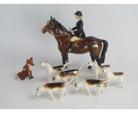 A Beswick Huntswoman (model 1730), with six fox hounds and seated fox 