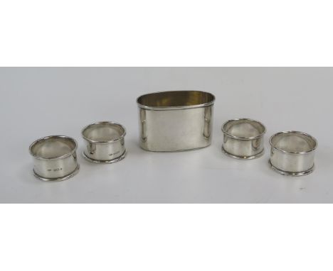 A mixed collection of silver wares, various makers and dates, includes four napkin rings and a silver flask base, total weigh