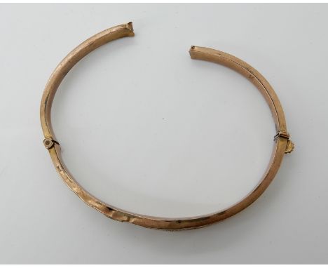 A 9ct gold engraved bangle (af) weight 6.9gms Condition Report: Available upon request