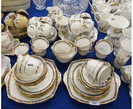 A Roslyn china teaset comprising eleven cups and saucers, eleven plates, cake plate, milk jug and sugar bowl together with a 