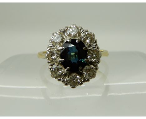 An 18ct gold sapphire and diamond cluster ring, diamonds estimated approx 1ct, the sapphire dimensions 6.9mm x 5.6mm x 3mm, f