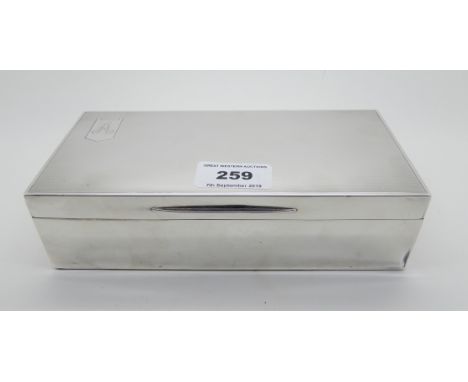A silver cigarette box, London 1939, of rectangular form with engine turned decoration, the hinged cover monogrammed "A" on o