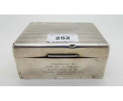A silver cigarette box, Birmingham 1923, of rectangular form with engine turned decoration, the hinged cover monogrammed "RJP