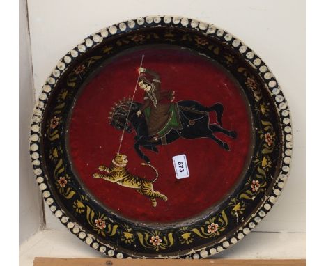An Indian papier mache dish depicting a man hunting a tiger Condition Report: Available upon request