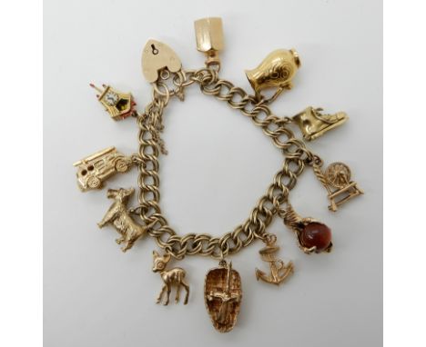 A 9ct gold charm bracelet with attached gold and yellow metal charms total weight 49.5gms Condition Report: Nice double link 