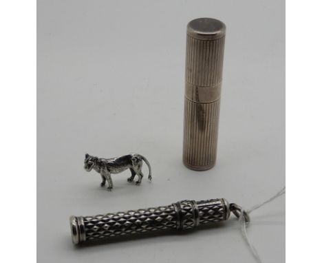 A lot comprising a continental silver etui with manicure tools, a white metal pencil by Sampson Mordan and a small silver dog