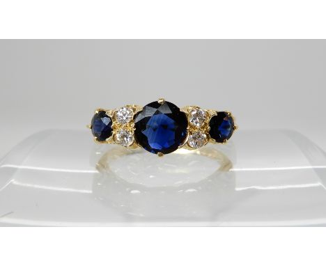 An 18ct gold sapphire and diamond scroll mount ring size N1/2, largest sapphire approx 6.8mm x 3mm, weight 3.5gms Condition R