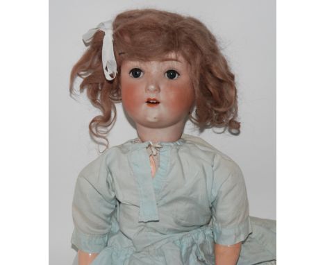 A Simon and Halbig bisque-head doll with open and close blue eyes, open mouth and painted features with impressed factory mar