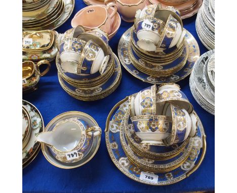 Noritake blue and gilt decorated teaset on white ground comprising twelve cups, saucers and plates, two cake plates, milk jug