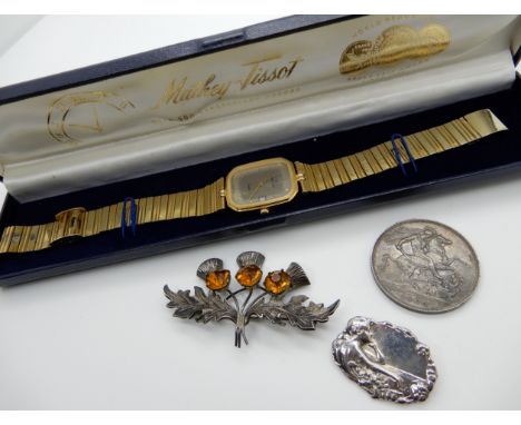 A gold plated Mathey-Tissot gold plated watch, a silver thistle brooch, an Art Nouveau style brooch and a Victoria 1900 Crown