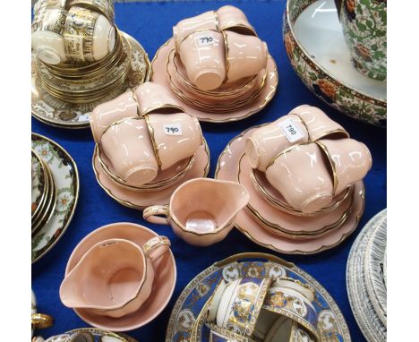 A Grindley Peachpetal teaset comprising two cake plates, twelve cups, saucers and plates, two milk jugs and a sugar bowl Cond