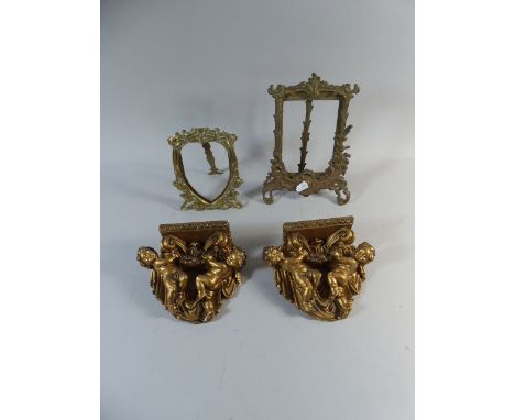 A Pair of Plaster Cherub Wall Sconces and Two Brass Easel Photo Frames