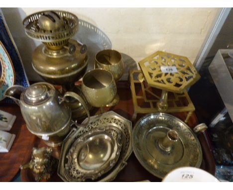 A Tray of Metal Ware to Include Brass Trivets, Brass Oil Lamp, Silver Plated Jug, Brass Terrier, Silver Plated Bed Chamber St