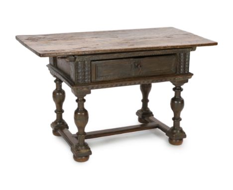 A late 17th century Dutch oak side table, with rectangular top and frieze drawer, on baluster legs with H stretcher and bun f