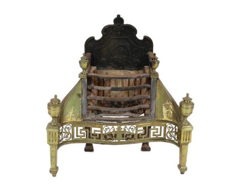 A George III brass mounted wrought and cast iron fire grate, of serpentine form, with pierced decoration and urn finials, 70c