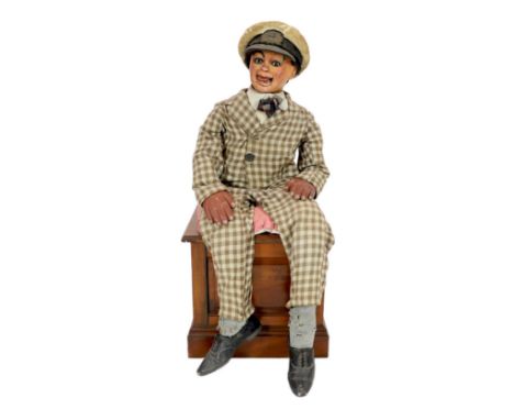 A Leonard Insull ventriloquist's dummy, dressed in a check suit and wearing a sailor's cap, approx. 130cm high, with walnut b