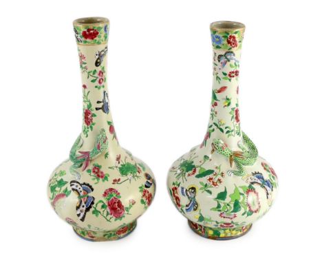 A pair of Chinese enamelled porcelain crackle glaze bottle vases, mid 19th century, each painted with butterflies and flowers