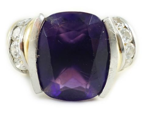 A modern 18ct gold and cushion cut amethyst set dress ring, with ten stone round cut diamond set shoulders, size N, gross wei