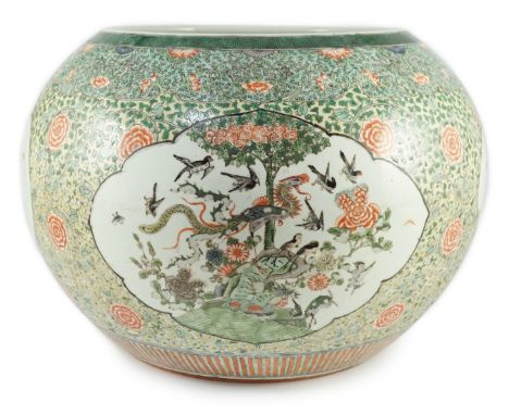A large Chinese famille verte jardiniere or fish bowl, 19th century, painted to four reserves with a phoenix, magpies and oth
