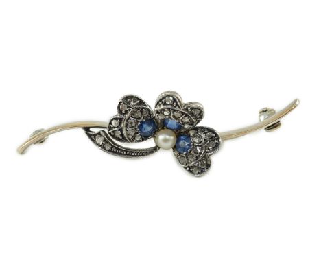 A 1920’s white gold, sapphire, cultured pearl and rose cut diamond set shamrock bar brooch, numbered 2436, 46mm, gross weight