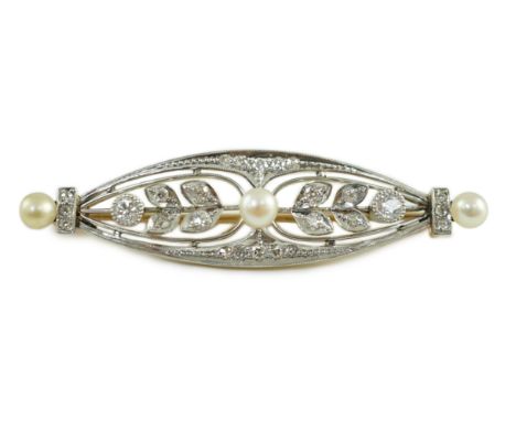An early to mid 20th century gold and platinum, pearl and round cut millegrain set diamond cluster oval brooch, 49mm, gross w