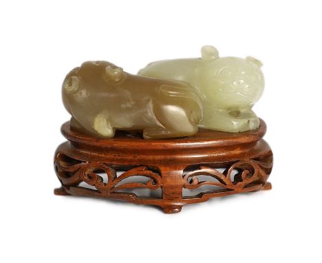 A Chinese pale celadon and brown jade group of two cats, 19th century, 5.1cm, wood stand, tiny chips***CONDITION REPORT***Pro