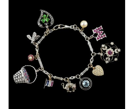 A French 18ct white gold circular and baton link charm bracelet, hung with eleven assorted charms, including 18k white gold, 
