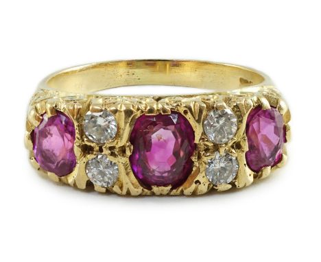 An early to mid 20th century 18ct gold, single stone oval cut ruby, two stone pink sapphire and four stone round cut diamond 