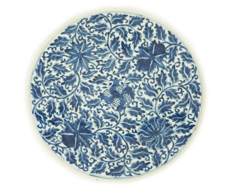 A Chinese blue and white dish, Kangxi mark, 19th century, the centre painted with four pomegranates surrounded by lotus flowe