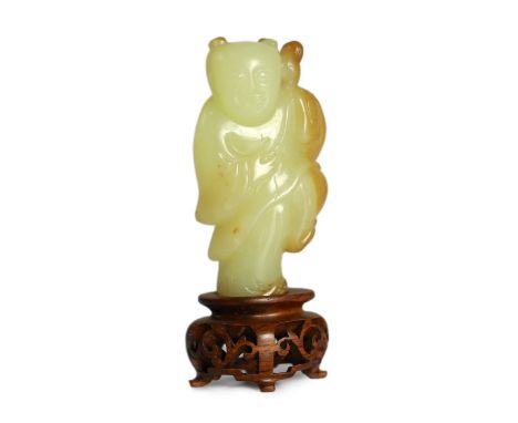 A rare Chinese yellow and russet jade figure of a boy holding a parrot, 18th/19th century, standing on one leg holding the pa