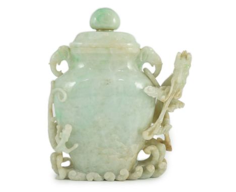 A Chinese jadeite 'dragon' vase and cover, late 19th/early 20th century, carved in high relief and openwork with a dragon abo