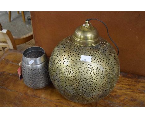 A metal pierced globe ceiling light and a similar candle stand