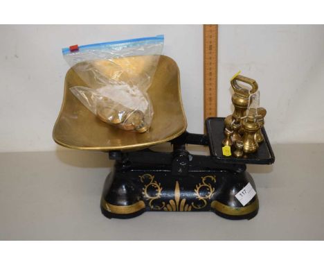 Pair of black and gilt painted scales and a quantity of weights
