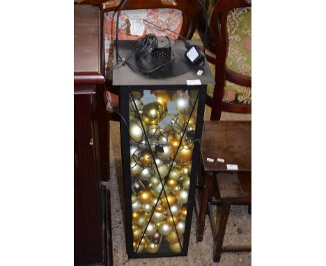 Large lantern filled with a quantity of Christmas baubles and fairy lights