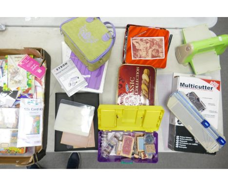 A large collection of craft card making materials and tools : to include stamps, beads, cutters, cutting mat , Xyron design r