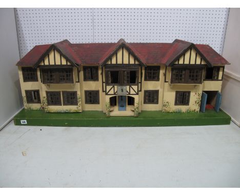 A Large Pre War Tri-ang Dolls House, in mock Tudor style, with electric lighting, four front opening doors, eight rooms, gara