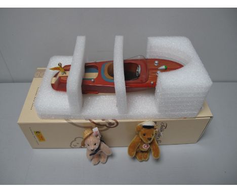 A Boxed Steiff #037405 Teddy Bear Set, with motor boat, the nostalgic motor boat is 32cm long and crafted in lacquered limewo