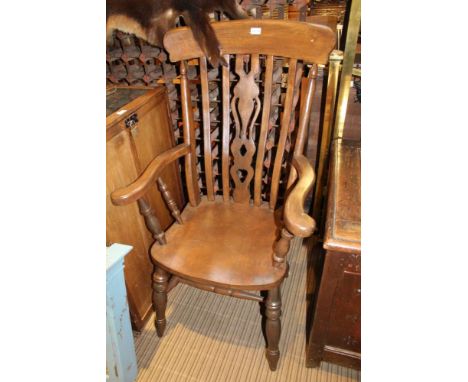 A STICK BACK COUNTRY KITCHEN ARMCHAIR with solid seat 