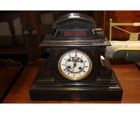 A 19TH CENTURY BLACK SLATE ARCHITECTURALLY CASED MANTEL CLOCK with key 