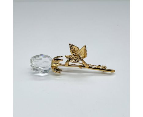 Clear faceted rose bud complemented by a gold-toned metal stem and pin hardware. This item has its original box which measure